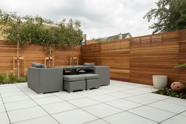 Wooden deck with railings and adjacent fence