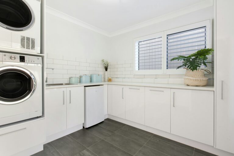 Functional laundry room with storage cabinets and appliances