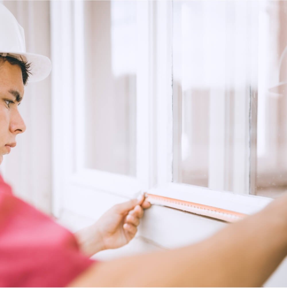 Centennial Windows and Doors Installation Expert Measuring Twice with Tape Measure