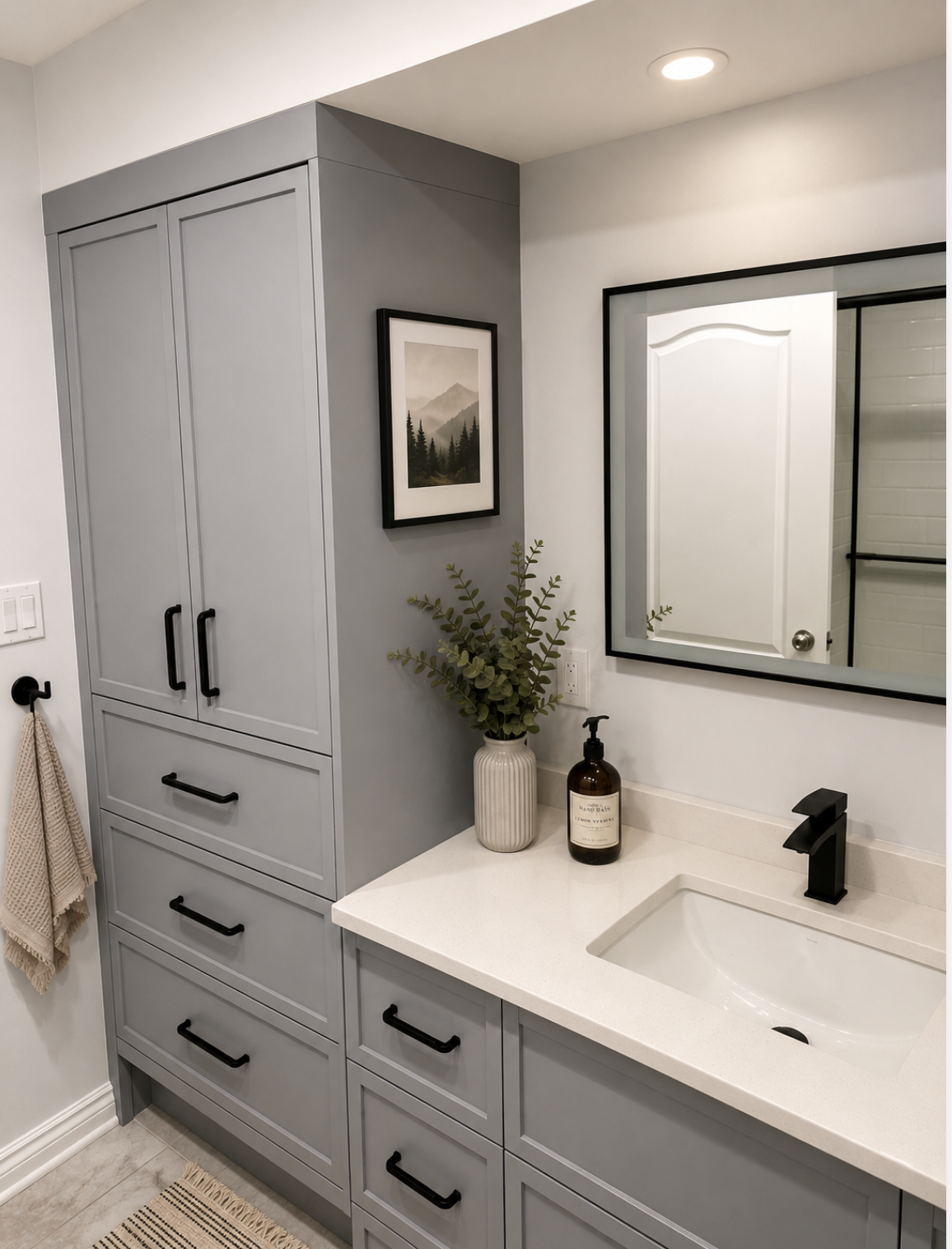 Bathroom vanity with grey cabinetry and black hardware