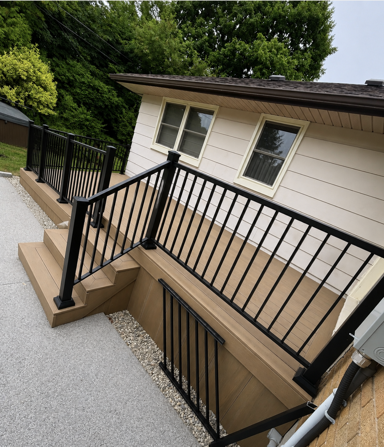 Deck with black metal railing and stairs