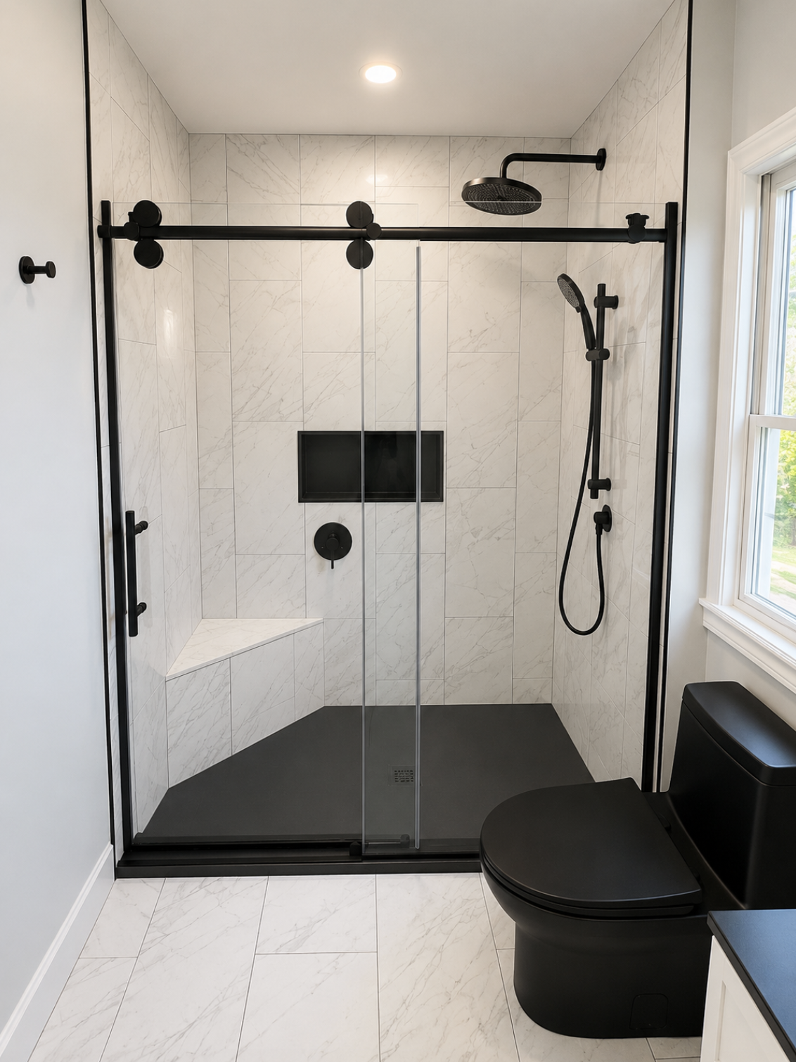 Bathroom shower with black hardware and hexagon tile flooring
